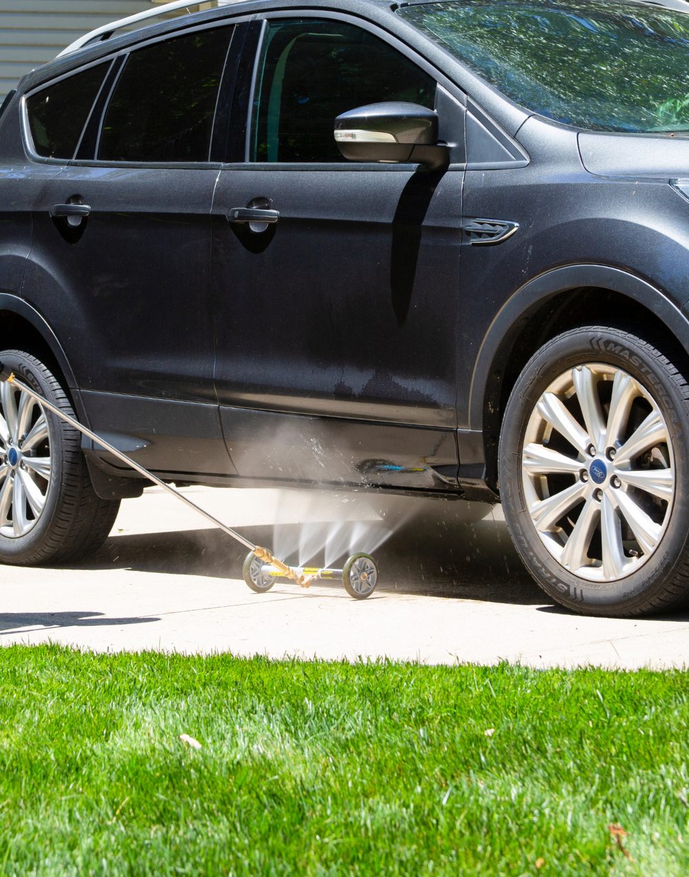 Washing an SUV with a pressure washer