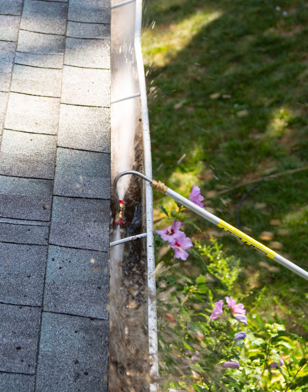 Cleaning a gutter with a gutter wand